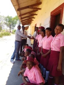 Girls from Thembalethu Foundation receive the footballs from Pendle Sportswear.